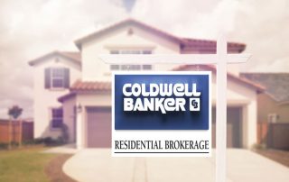 Coldwell Banker for sale sign in front of house